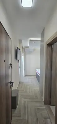 a room with a hallway with a door and a bedroom at Deluxe Apartmani Vila Pejovic Sutomore in Sutomore