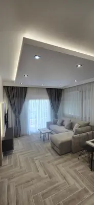 a large living room with a couch and a table at Deluxe Apartmani Vila Pejovic Sutomore in Sutomore