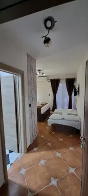 a bedroom with two beds and a view of the ocean at Deluxe Apartmani Vila Pejovic Sutomore in Sutomore