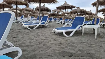 a group of chairs and umbrellas on a beach at Titi Luxury&Spa in Ulcinj