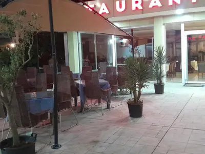 a restaurant with a table and chairs and plants at Titi Luxury&Spa in Ulcinj