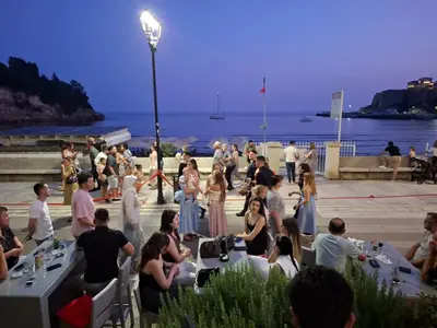 a group of people standing around at a party by the water at Titi Luxury&Spa in Ulcinj