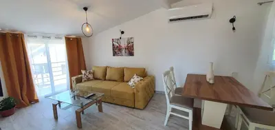 a living room with a couch and a table at The Apartment in Ulcinj