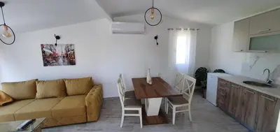 a living room with a couch and a table at The Apartment in Ulcinj
