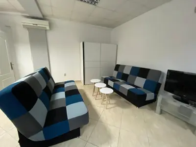 a living room with two couches and a flat screen tv at Apartman Marija in Ulcinj