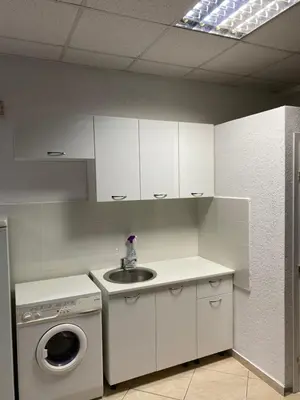 a kitchen with a sink and a washing machine at Apartman Marija in Ulcinj