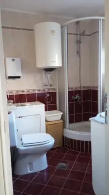 a bathroom with a toilet and a sink and a tub at Budva center apartmant in Budva
