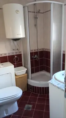 a bathroom with a shower and a toilet and a sink at Budva center apartmant in Budva