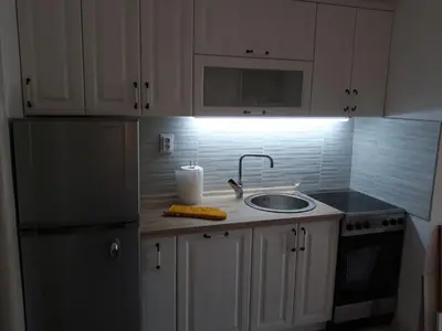 a kitchen with a sink and a refrigerator at Budva center apartmant in Budva