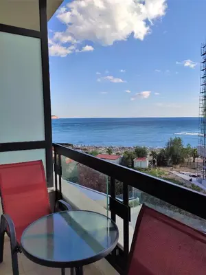 a balcony with a table and chairs and a view of the ocean at Silver Beachfront Becici in Becici