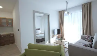 a living room with a couch and a mirror at Silver Beachfront Becici in Becici