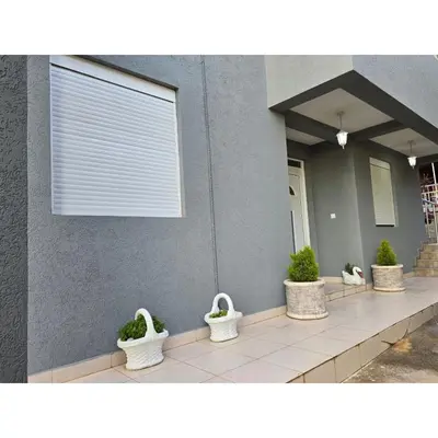 a row of white baskets with plants on a building at Family apartment-DiLorena in Bar