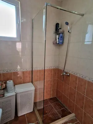 a shower with a glass door in a bathroom at Family apartment-DiLorena in Bar
