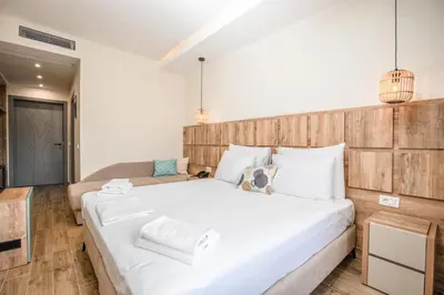 a bedroom with a large bed with white sheets at Hotel Olea in Ulcinj