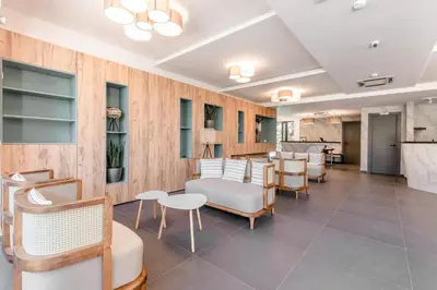 a waiting room with chairs and tables in a building at Hotel Olea in Ulcinj