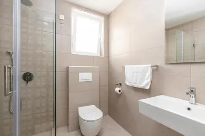 a bathroom with a toilet and a sink and a shower at Hotel Olea in Ulcinj