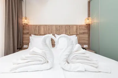 a pair of white socks sitting on top of a bed at Hotel Olea in Ulcinj