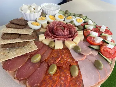 a plate of food with meats and cheese and crackers at IPN ROOMs in Mahala