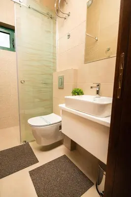 a bathroom with a sink and a toilet and a shower at IPN ROOMs in Mahala