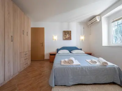 a bedroom with a bed with towels on it at Tomy Garden House in Budva
