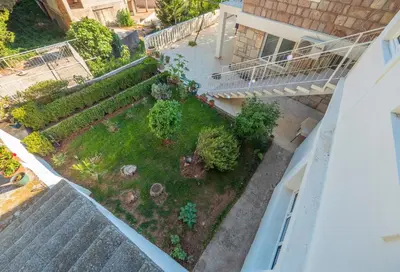 an aerial view of a garden in the middle of a building at Tomy Garden House in Budva