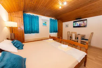 a bedroom with a large bed and a table at BARBARA101 in Kotor