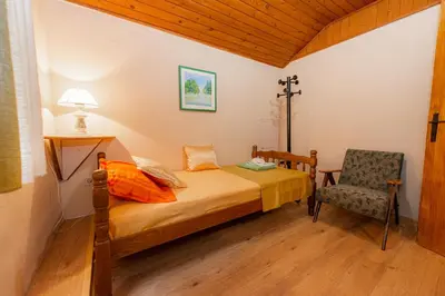 a bedroom with a bed and a chair at BARBARA101 in Kotor