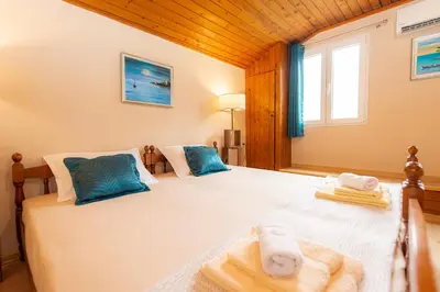 a bedroom with two beds with towels and a window at BARBARA101 in Kotor