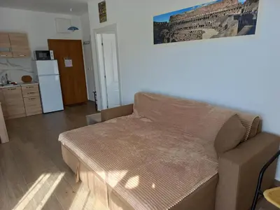 a living room with a couch and a refrigerator at Sea View Dobra Voda in Dobra Voda