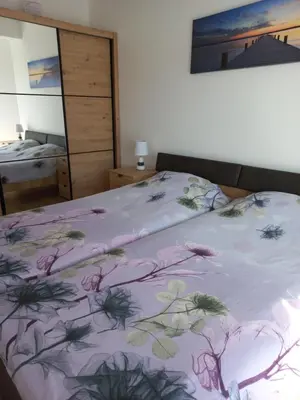 a bedroom with a bed with a purple blanket at Sea View Dobra Voda in Dobra Voda