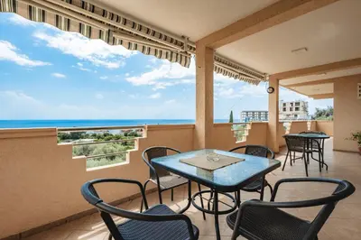 a balcony with tables and chairs and a view of the ocean at OLIVE GARDEN APARTMENT in Bar