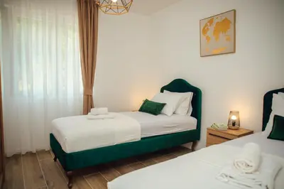 a small bedroom with two beds and a window at Baia di Cattaro in Kotor
