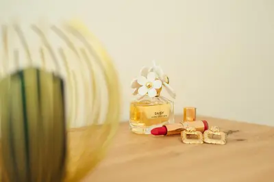 a bottle of perfume with a flower on a table at Baia di Cattaro in Kotor