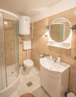 a bathroom with a sink toilet and a mirror at Apartments Radimir in Kotor