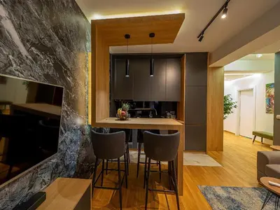 a kitchen and living room with a table and chairs at Night Pearl - Deluxe Apartment in Bar