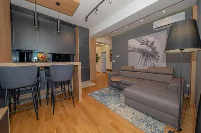 a kitchen and living room with a couch and a bar at Night Pearl - Deluxe Apartment in Bar
