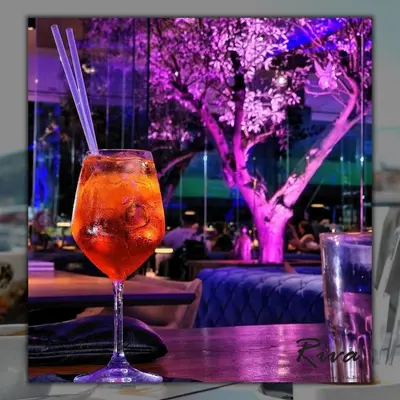 a drink in a glass sitting on a table at Hotel Riva in Budva