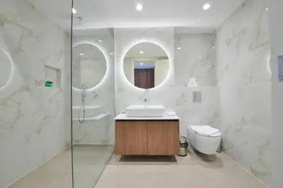 a bathroom with a sink and a toilet and a mirror at Hotel Riva in Budva