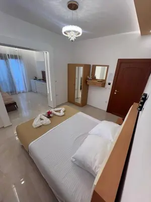 a bedroom with a large white bed in a room at City Heart Apartments in Ulcinj