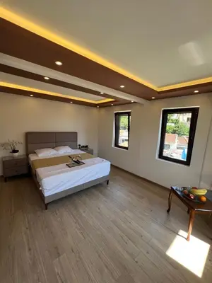 a large bedroom with a large bed and a table at City Heart Apartments in Ulcinj
