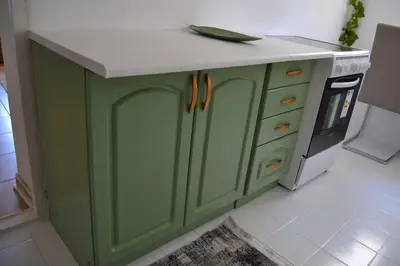 a green kitchen island with a white counter top at Una Apartment Cetinje in Cetinje