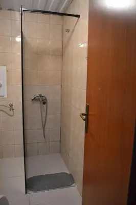 a bathroom with a shower with a glass door at Una Apartment Cetinje in Cetinje
