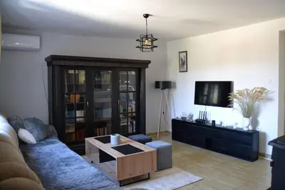 a living room with a couch and a coffee table at Una Apartment Cetinje in Cetinje