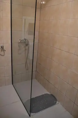 a shower with a glass door in a bathroom at Una Apartment Cetinje in Cetinje