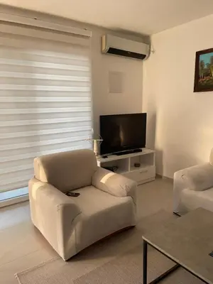 a living room with a couch and a flat screen tv at Sam Villa in Ulcinj