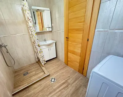 a bathroom with a shower and a sink and a toilet at Talia Apartments in Budva