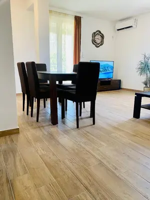 a dining room with a table and chairs at Talia Apartments in Budva