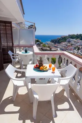 a white table and chairs on a balcony at Castello Apartments in Ulcinj