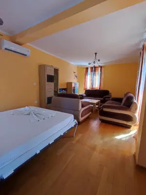 a living room with a bed and two couches at Apartmani Vuković- Brca in Sutomore
