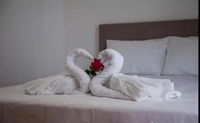 two swans made out of towels on a bed at DeLux Apartmani in Dobra Voda